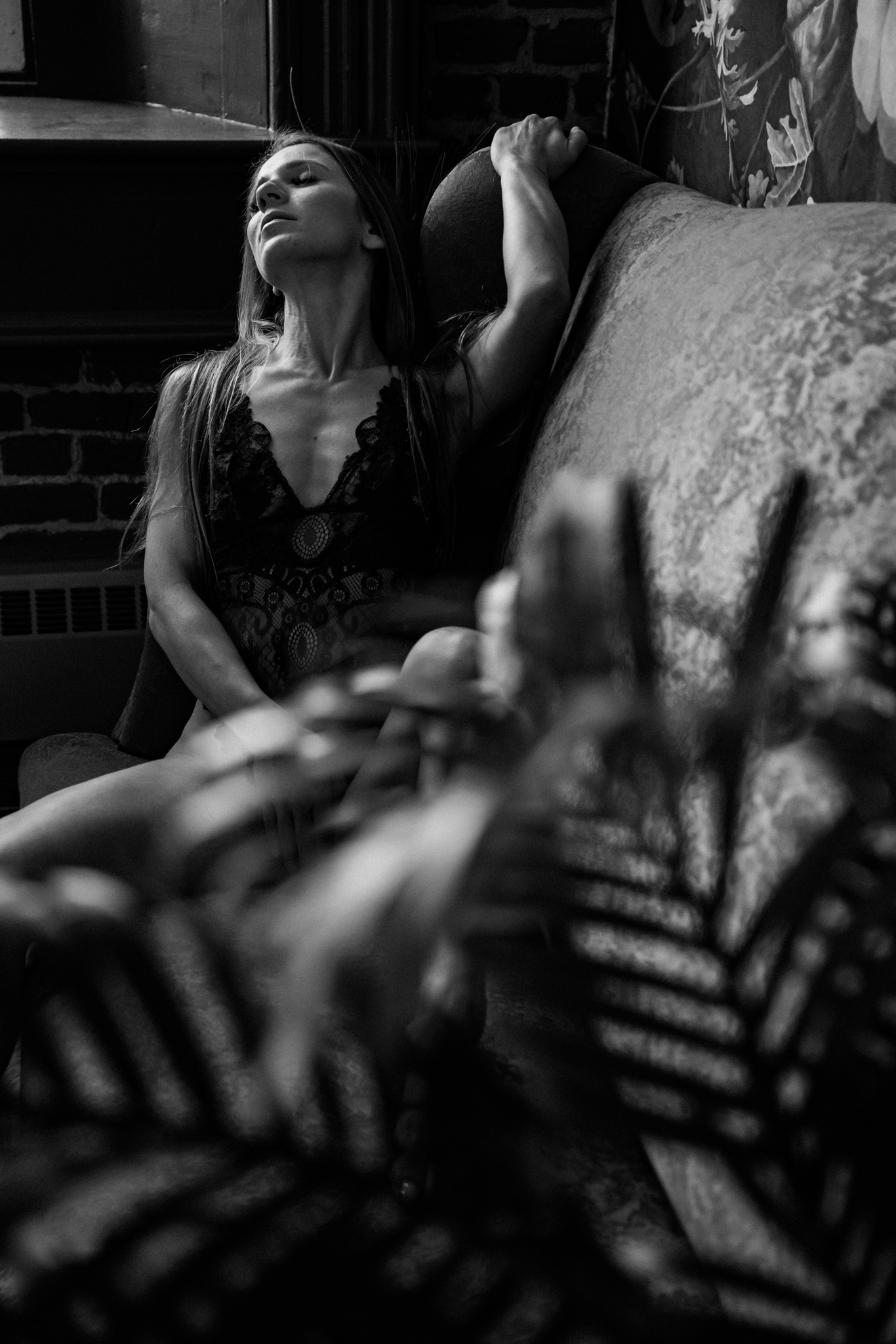 black and white photo of a woman lounging during her empowering photoshoot with Kimberly Ann Boudoir 