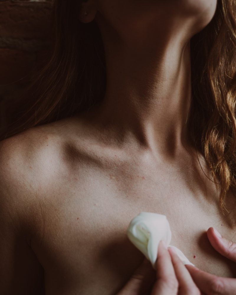 boudoir photography detail shot highlighting a woman's neck and collar bone