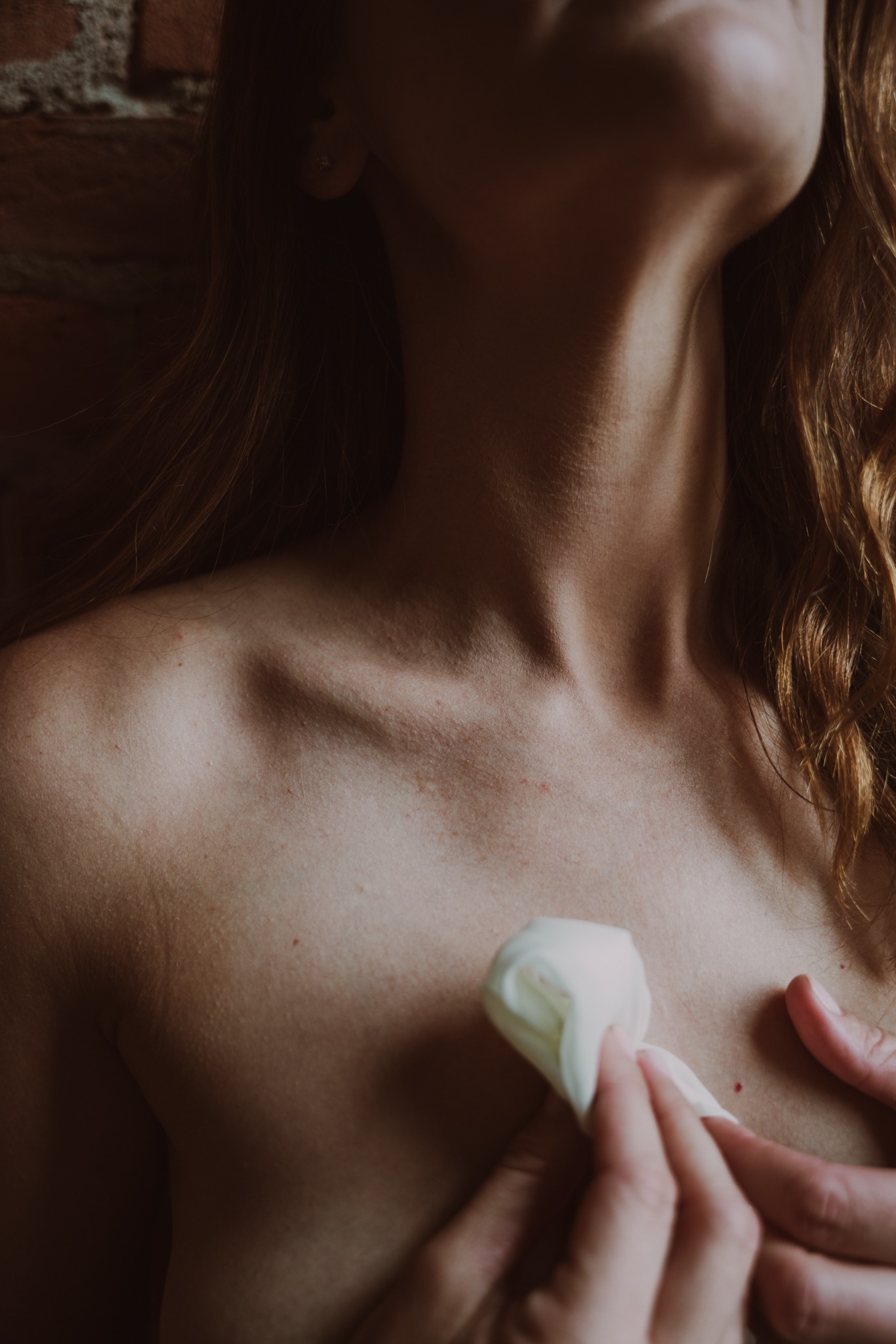 close up of woman's collarbone while her hands rest on her chest during her boudoir session in Humboldt County