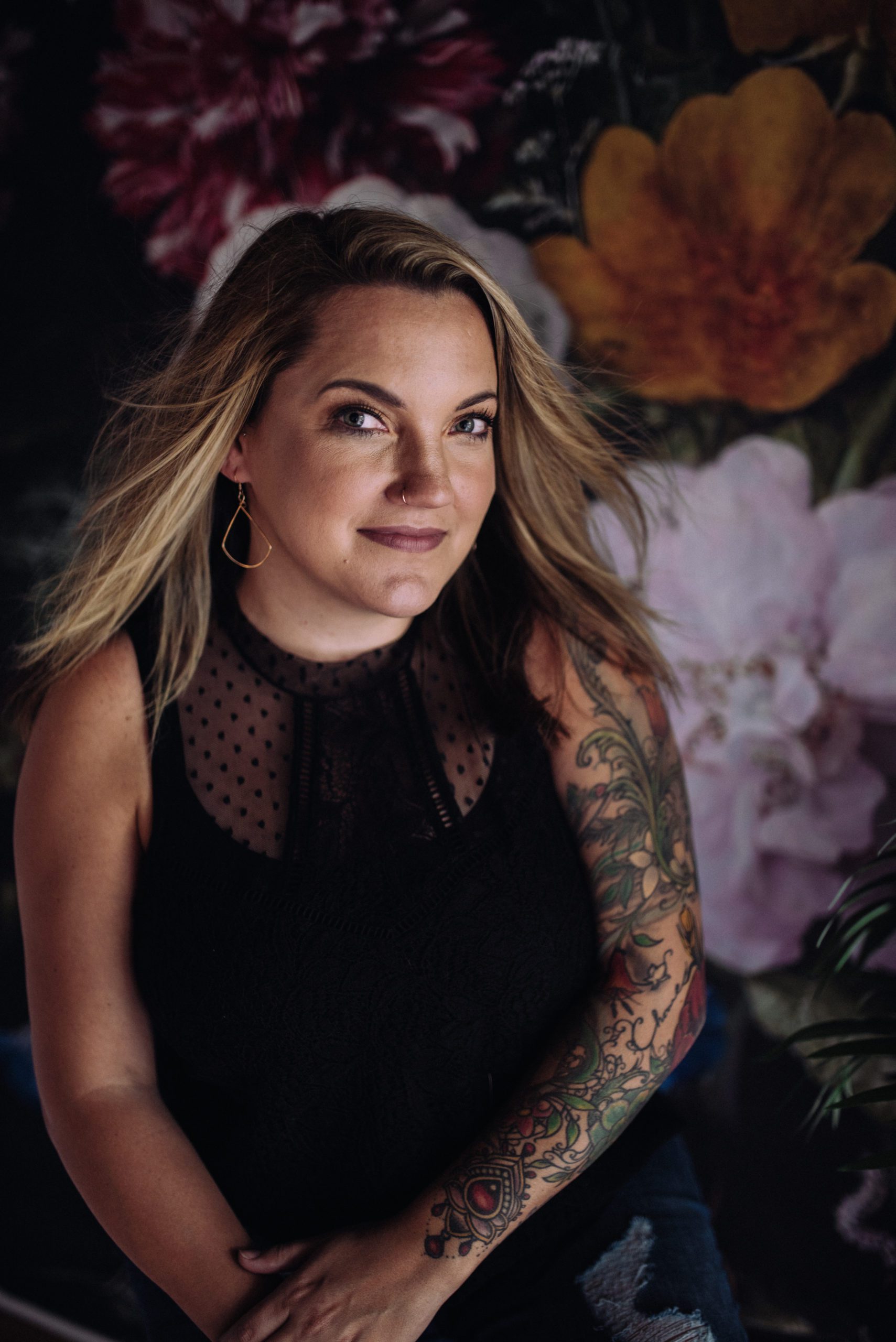 luxe headshot of a woman with a sleeve tattoo taken in Sacramento after her boudoir photoshoot